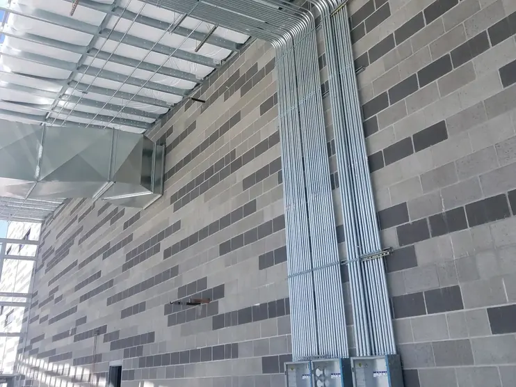 EMT conduit runs on a commercial building wall installed by ZAP Industries