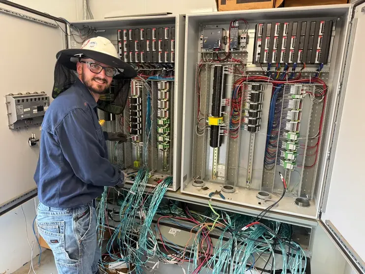 Electrician wiring an industrial control panel