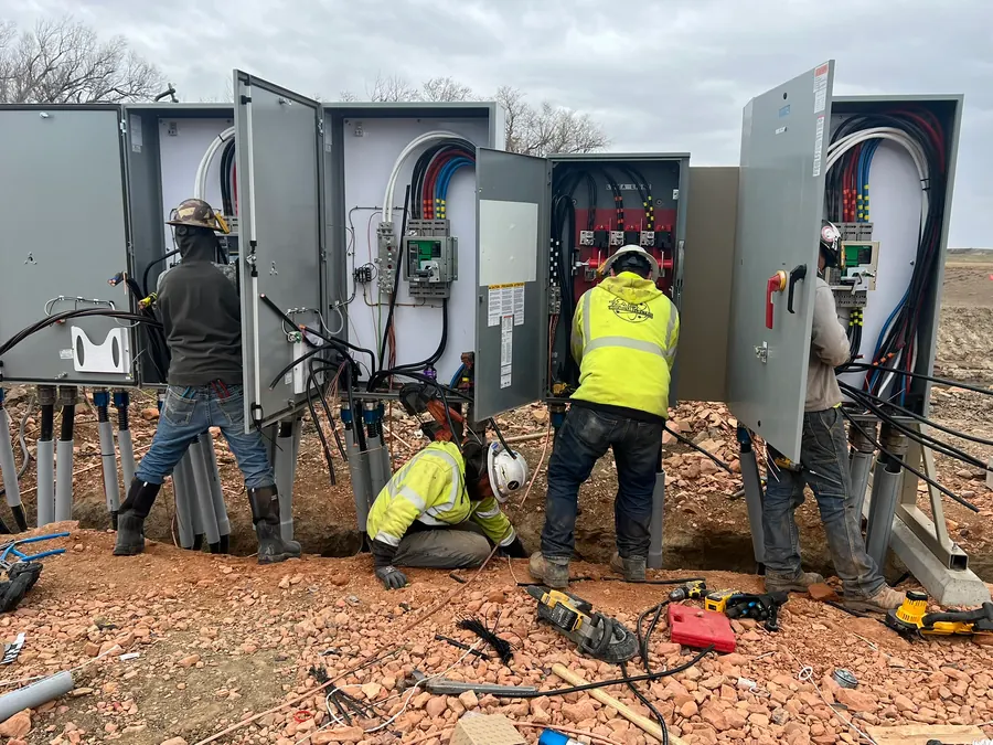 Crew installing commercial electrical panels